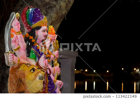 Hindu colored statue of Shiva God in Hinduism at Pushkar Sarovar Lake in night. Hindu colored statue of Shiva God in Hinduism at Pushkar Sarovar Lake in night. 113422149