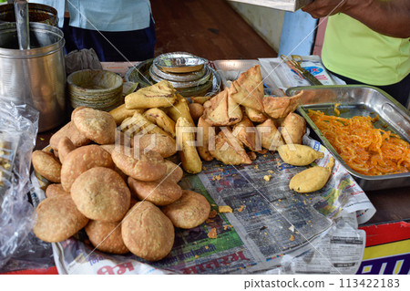 Traditional Namkeen Indian snacks and Samosas frying on street food and markets Traditional Namkeen Indian snacks and Samosas frying on street food and markets 113422183