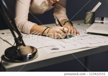 Crop woman making blueprints Crop woman making blueprints 113422531