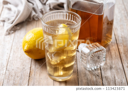 Highball, Whiskey with soda and lemon beverage on wooden table Highball, Whiskey with soda and lemon beverage on wooden table 113423871