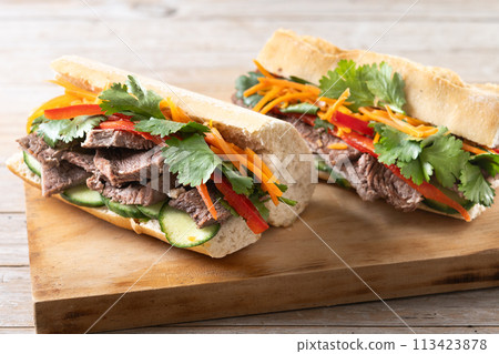 Vietnamese banh mi sandwich on wooden table Vietnamese banh mi sandwich on wooden table 113423878
