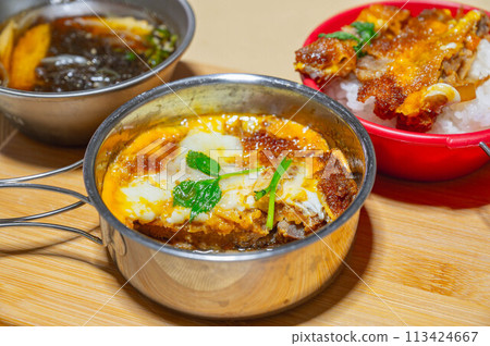 Katsudon (pork cutlet rice bowl) eaten outdoors 113424667