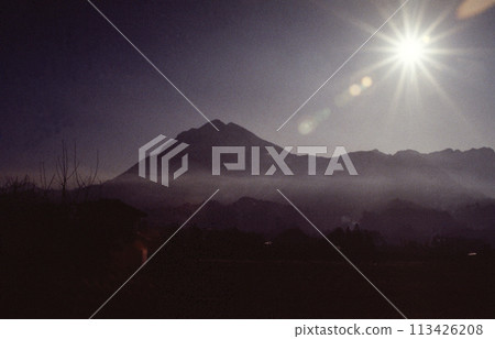 Morning mist and the sun shining on Mt. Buko 113426208