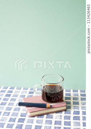 Diary notebook, pencil, coffee on blue tile desk. mint wall background. workspace Diary notebook, pencil, coffee on blue tile desk. mint wall background. workspace 113426465