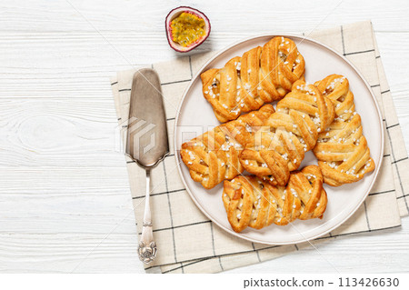 passion fruit puff pastry turnovers on a plate passion fruit puff pastry turnovers on a plate 113426630