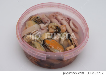 A pile of marinated seafood cocktail in a bowl, a side dish for buckwheat porridge. 113427717