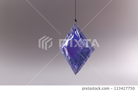 Condom package on a gray background. Safe sex and health 113427750
