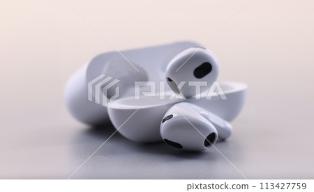 White electronic bluetooth headphones and technical cases on white background White electronic bluetooth headphones and technical cases on white background 113427759