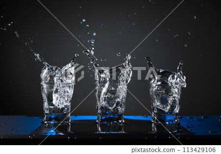 Alcoholic shots of vodka or strong drink in small glasses. 113429106