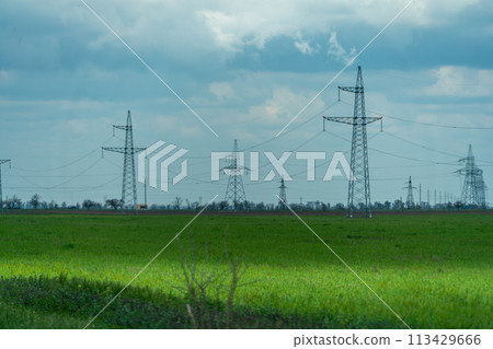 High voltage towers with sky background. Power line support with wires for electricity transmission. High voltage grid tower with wire cable at distribution station. Energy industry, energy saving High voltage towers with sky background. Power line support with wires for electricity transmission. High voltage grid tower with wire cable at distribution station. Energy industry, energy saving 113429666