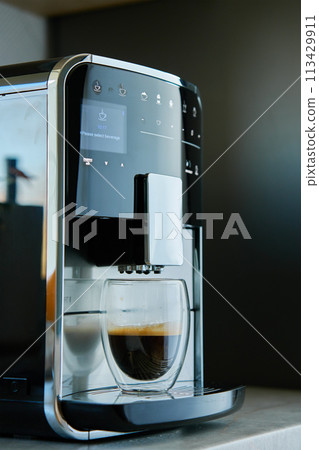 Fresh espresso at morning. Coffee machine with freshly brewed coffee in glass cup. Kitchen appliances Fresh espresso at morning. Coffee machine with freshly brewed coffee in glass cup. Kitchen appliances 113429911