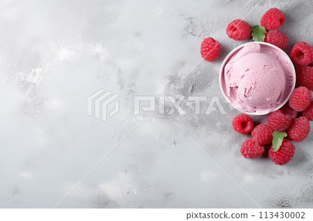 A bowl of creamy yogurt topped with fresh raspberries on a minimalist grey background. A bowl of creamy yogurt topped with fresh raspberries on a minimalist grey background. 113430002
