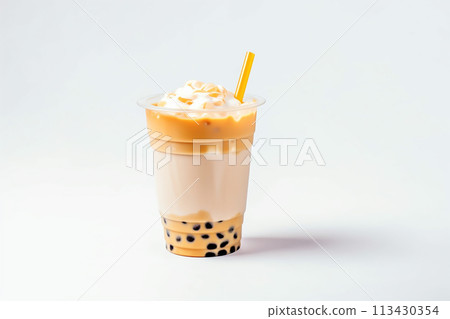 A yellow milkshake topped with whipped cream, sprinkles, and a straw. 113430354