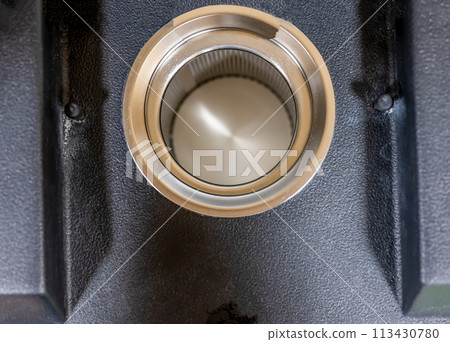 Selective focus on edge of spinning swimsuit dryer with metal screen. 113430780