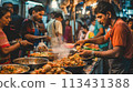 Mumbai. Street food in action with vada pav, Mumbai's favorite, attracting a crowd 113431388