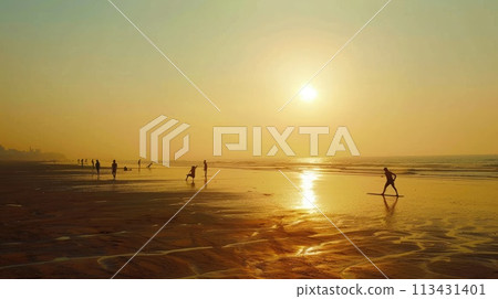 Mumbai. Juhu Beach at dawn: joggers, yoga, vast sand, rising sun in serene setting 113431401