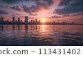 Mumbai. Tranquil sunset over Marine Drive with calm seas and Mumbai's skyline 113431402