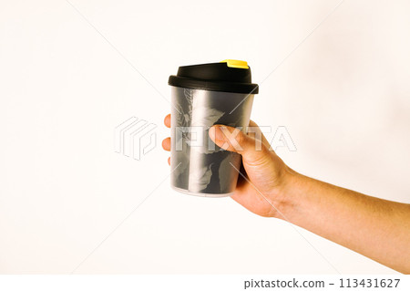 Male hand holding a tumbler on white background Male hand holding a tumbler on white background 113431627