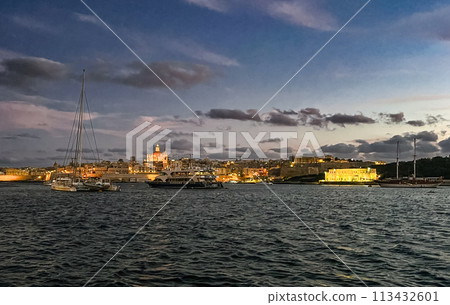 Beautiful sunset at Sliema embankment, Malta with the view on light city Beautiful sunset at Sliema embankment, Malta with the view on light city 113432601