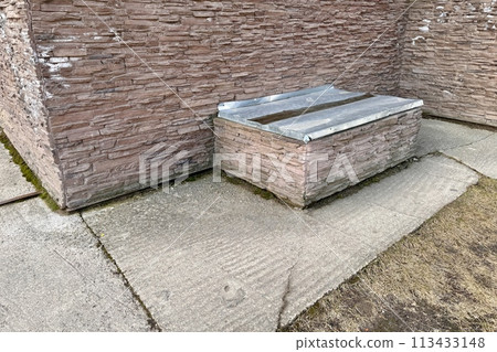 Basement opens in the building of house has window is located below ground level around facing brick. Window is covered with galvanized steel sheet to protect basement from precipitation during rain Basement opens in the building of house has window is located below ground level around facing brick. Window is covered with galvanized steel sheet to protect basement from precipitation during rain 113433148