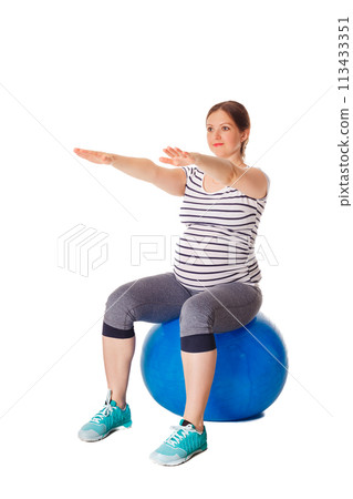 Pregnancy exercise concept - pregnant woman doing exercises with exercise ball isolated on white background 113433351