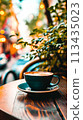 A cup of coffee sitting on a table outside near some trees, AI 113435023