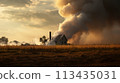 a column of smoke rises into the air above a house in the distance in a field 113435031