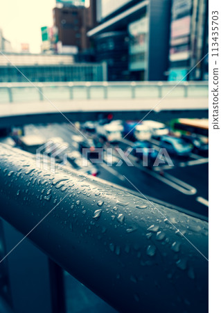 Raindrops on a pedestrian bridge, Shibuya Station East Exit Intersection, Tokyo 2024.04 b-3 Warm colors added 113435703