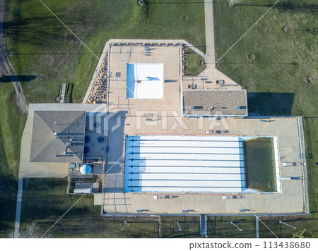 Drone view of an empty and drained winterized swimming pool  113438680