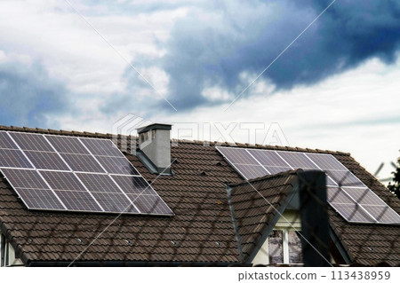 Historic farm house with modern solar panels on roof and wall 113438959