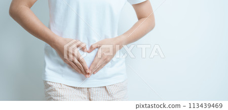 Woman hand heart shape over abdomen. Ovarian and Cervical cancer, Endometriosis, Hysterectomy, Uterine fibroids, Reproductive, menstruation, Stomach, Pregnancy and Sexual Transmitted disease concept 113439469