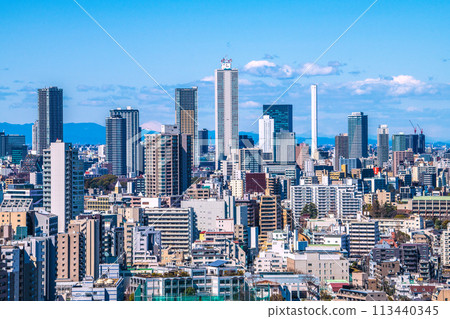 Tokyo cityscape in Japan: A rare view of the mountains... Ikebukuro subcenter. View of Sunshine 60 and tower apartments 113440345