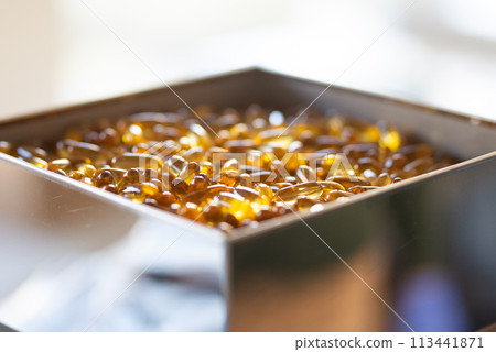 Vitamin omega capsules. Medicine vitamins and dietary supplements. Selective focus. Close up of oil filled capsules suitable for: fish oil, omega 3, omega 6, omega 9, vitamin A, vitamin D, vitamin D3 Vitamin omega capsules. Medicine vitamins and dietary supplements. Selective focus. Close up of oil filled capsules suitable for: fish oil, omega 3, omega 6, omega 9, vitamin A, vitamin D, vitamin D3 113441871