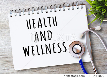 Business quotes, HEALTH AND WELLNESS on notebooks or paper in office desk Business quotes, HEALTH AND WELLNESS on notebooks or paper in office desk 113441872