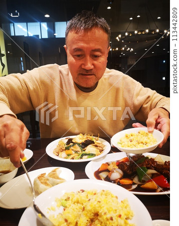 A Japanese man eating at a Chinese restaurant A Japanese man eating at a Chinese restaurant 113442809