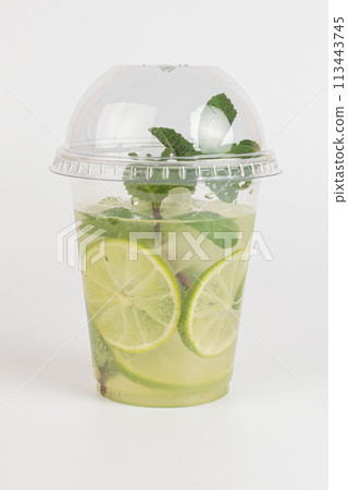 Cool delicious mojito cocktail decorated with mint and a slice of lime. Close-up, on a white background. Mock up. Cool delicious mojito cocktail decorated with mint and a slice of lime. Close-up, on a white background. Mock up. 113443745