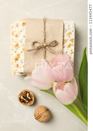 Matzo, nut and flowers on light background, top view 113445477