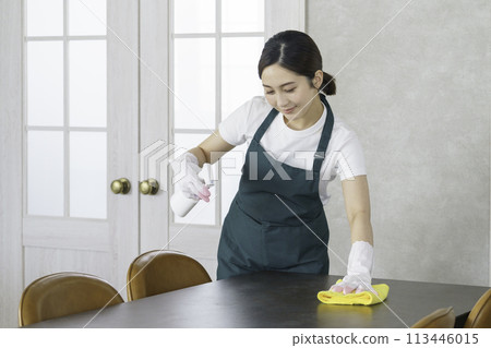 Housekeeping: Young female staff wiping the table 113446015