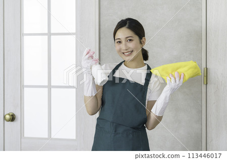Housekeeping: Young female staff wiping the table 113446017