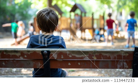Thoughtful Boy Sitting Alone in Park 113447233