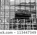 People cleaning the windows of a building 113447349
