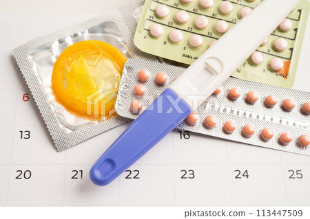 Pregnancy test and birth control pills on calendar, contraception health and medicine. Pregnancy test and birth control pills on calendar, contraception health and medicine. 113447509