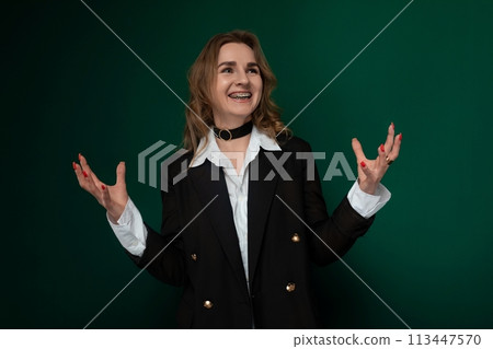 Woman Standing in Front of Green Wall 113447570