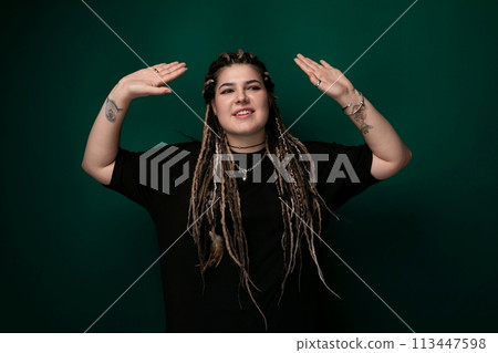 Woman With Dreadlocks in Front of Green Background Woman With Dreadlocks in Front of Green Background 113447598