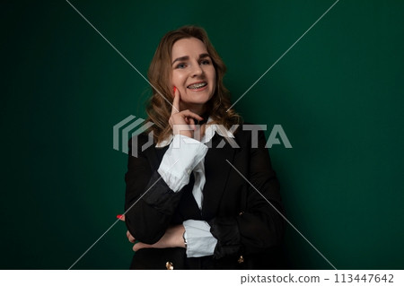 Woman Posing in Front of a Green Wall Woman Posing in Front of a Green Wall 113447642
