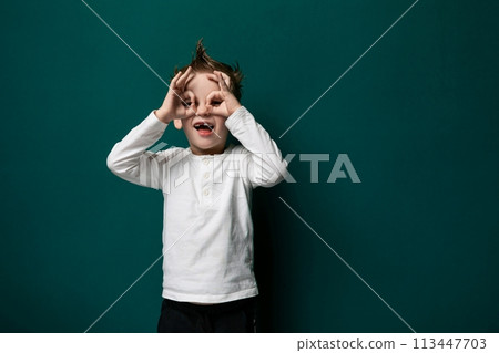 Young Boy Covering His Eyes With His Hands 113447703