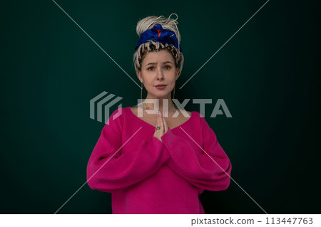 Woman in Pink Top Standing With Hands Folded 113447763