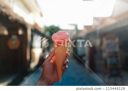 Eating ice cream in the streets of 113448129