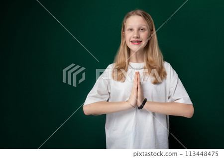 Woman Standing in Front of Green Wall Woman Standing in Front of Green Wall 113448475