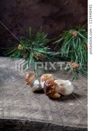 Porcini mushroom commonly known as Boletus Edulis on vintage wooden background.. Porcini mushroom commonly known as Boletus Edulis on vintage wooden background.. 113448491